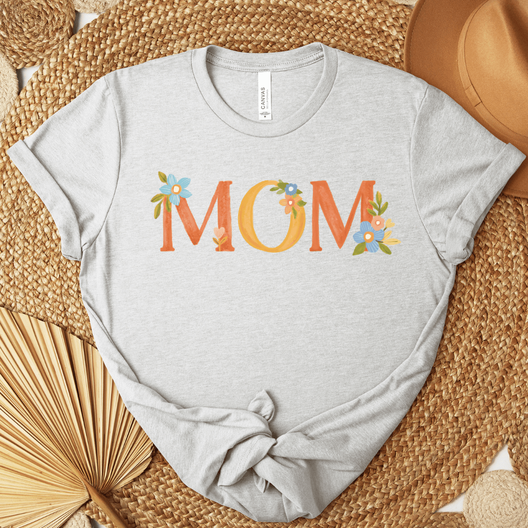 Ash Bella+Canvas 3001 t-shirt with floral MOM lettering in warm oranges and blues