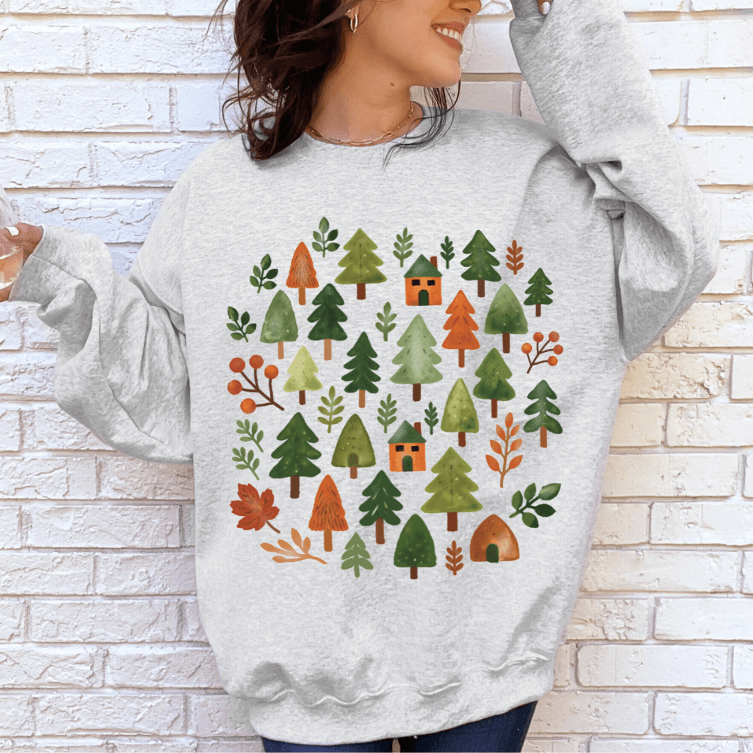 Ash Gildan 18000 crewneck sweatshirt with cozy forest scene illustration