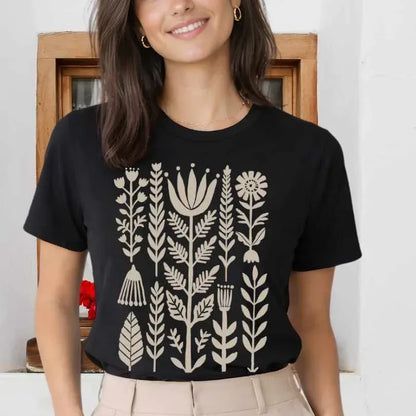 Black Bella+Canvas 3001 tee with minimal folk floral and seed head graphic