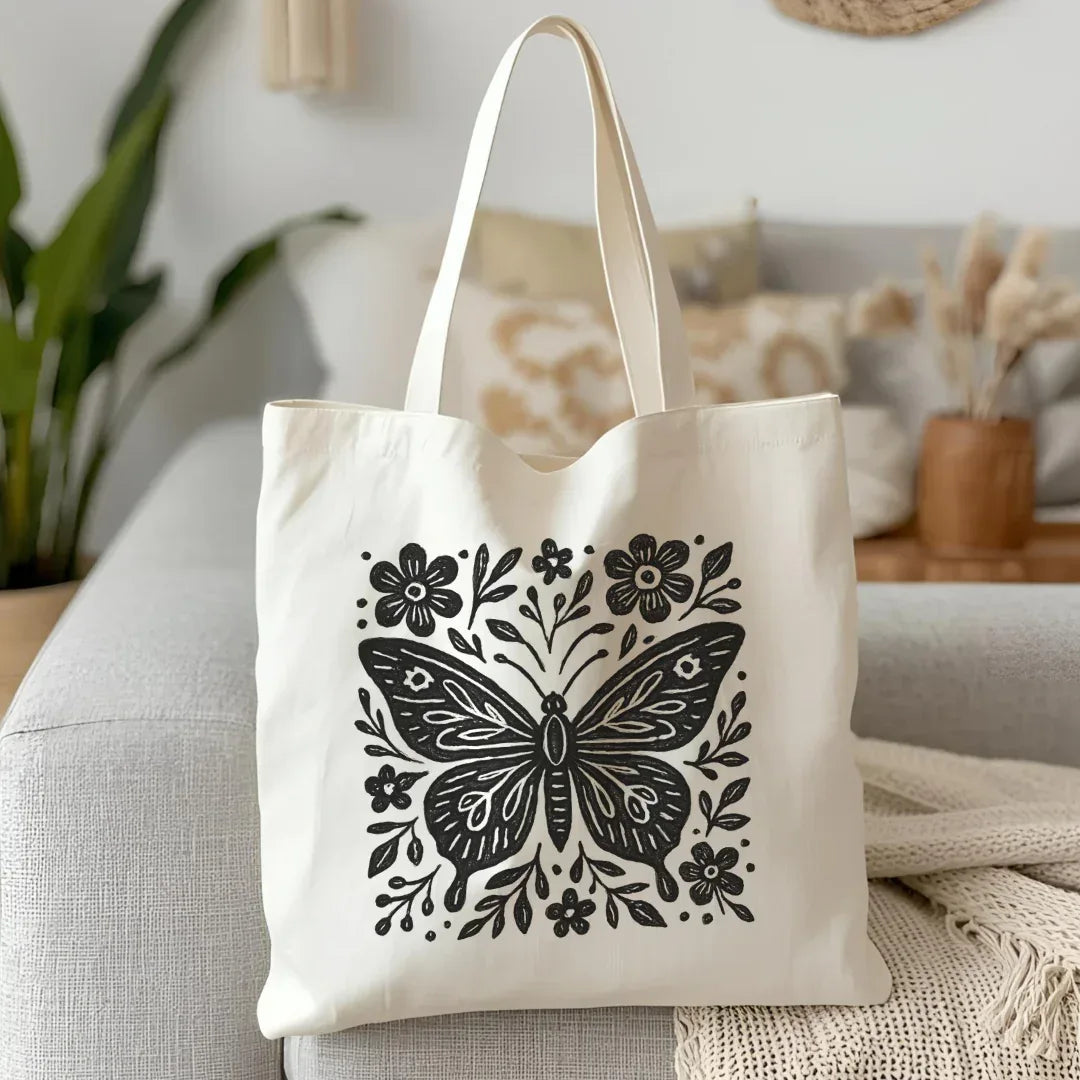 Folk black butterfly folk art print on natural cotton canvas tote — graphic block print butterfly bag