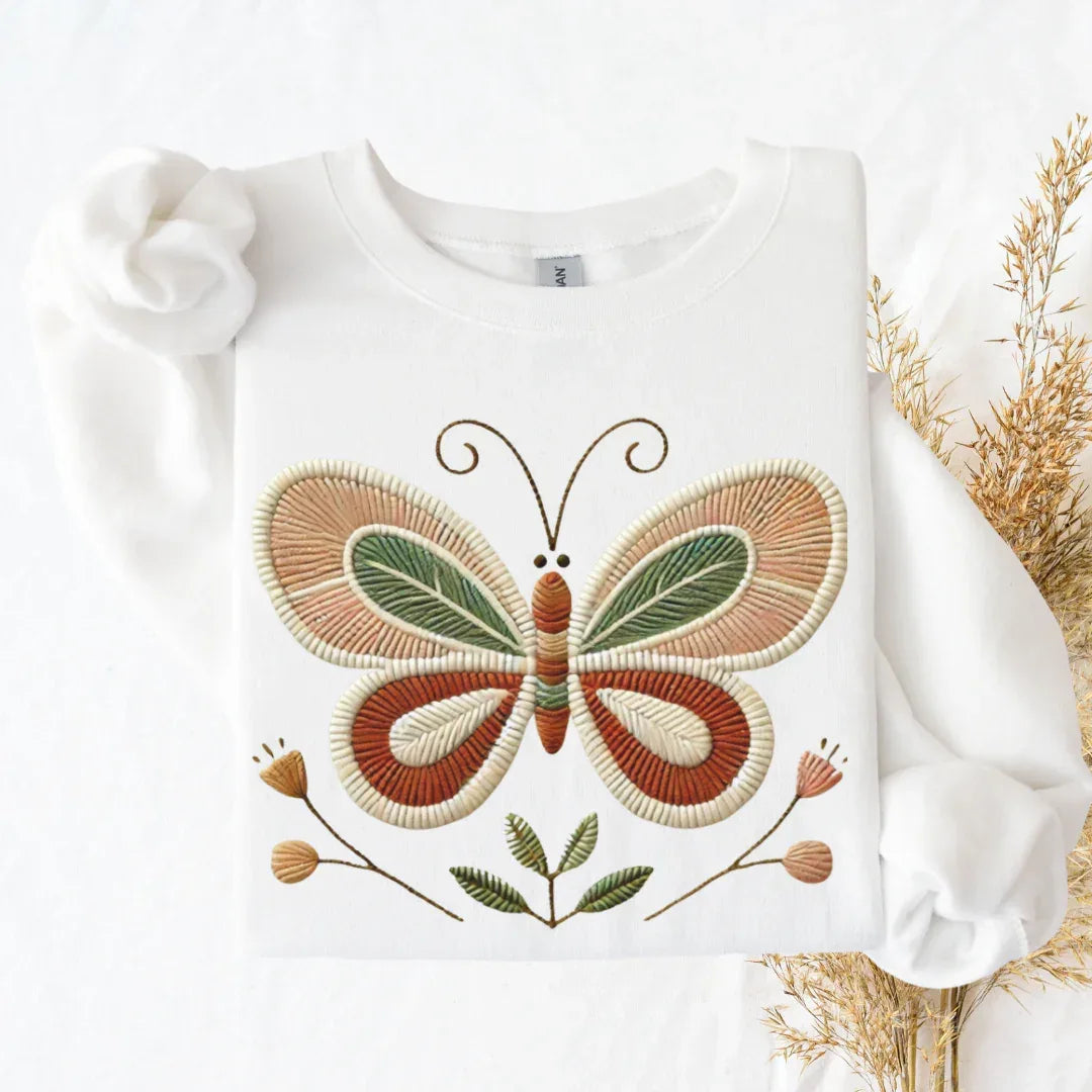 Folk butterfly faux embroidery print detail — terracotta olive and earth tones stitched look sweatshirt