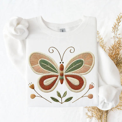 Folk butterfly faux embroidery print detail — terracotta olive and earth tones stitched look sweatshirt