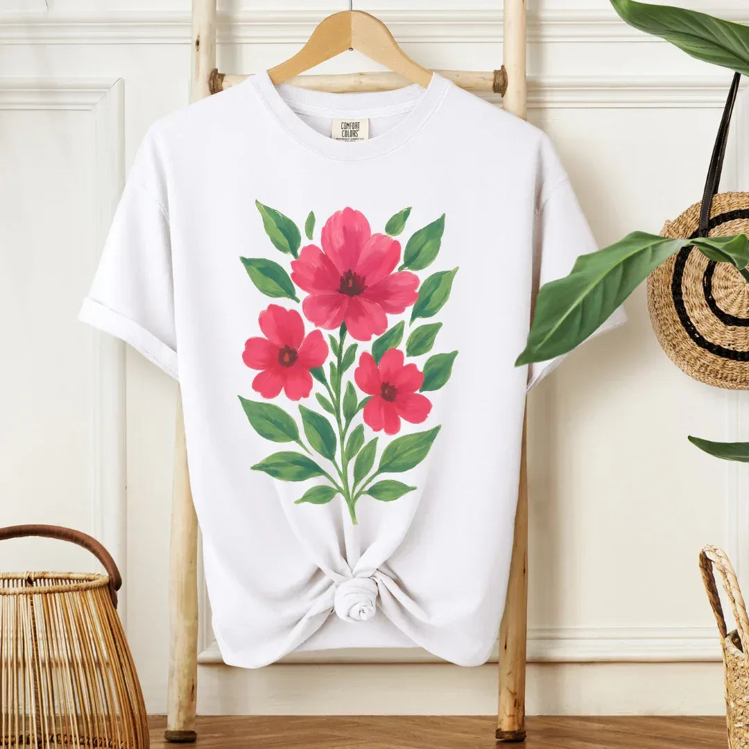 Hand-painted bold pink hibiscus blooms folk art print on white cotton tee — bright floral folk design