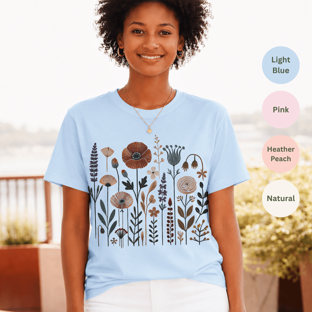 Light blue Bella+Canvas 3001 t-shirt with folk wildflower meadow illustration in earthy tones