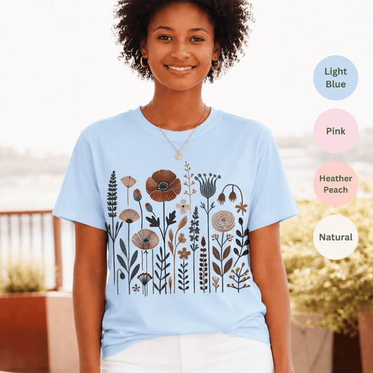 Light blue Bella+Canvas 3001 t-shirt with folk wildflower meadow illustration in earthy tones
