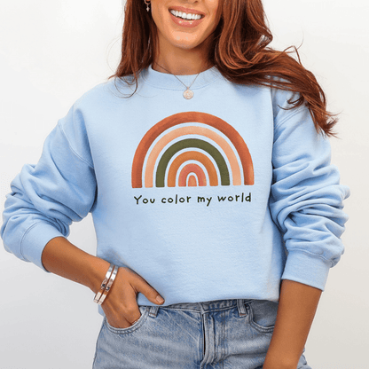 Light blue Gildan 18000 crewneck with muted rainbow and hand-lettered phrase