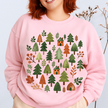 Light pink Gildan 18000 sweatshirt with woodland trees and cabins graphic in warm fall tones