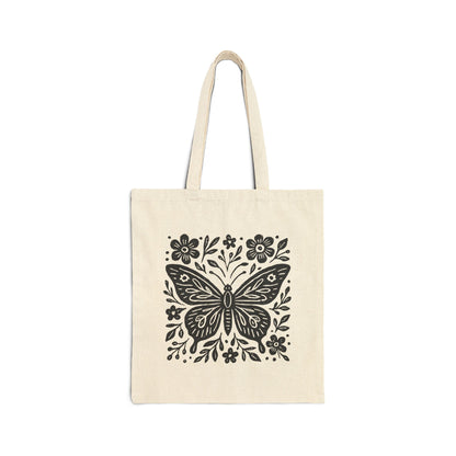 Natural canvas cotton tote bag with bold black folk art butterfly and floral graphic