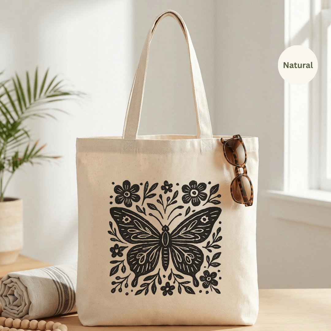Natural canvas cotton tote bag with bold black folk art butterfly and floral graphic