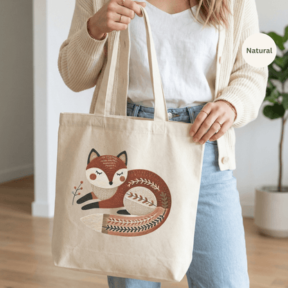 Natural canvas cotton tote bag with folk art sleeping fox illustration in warm rust and brown tones