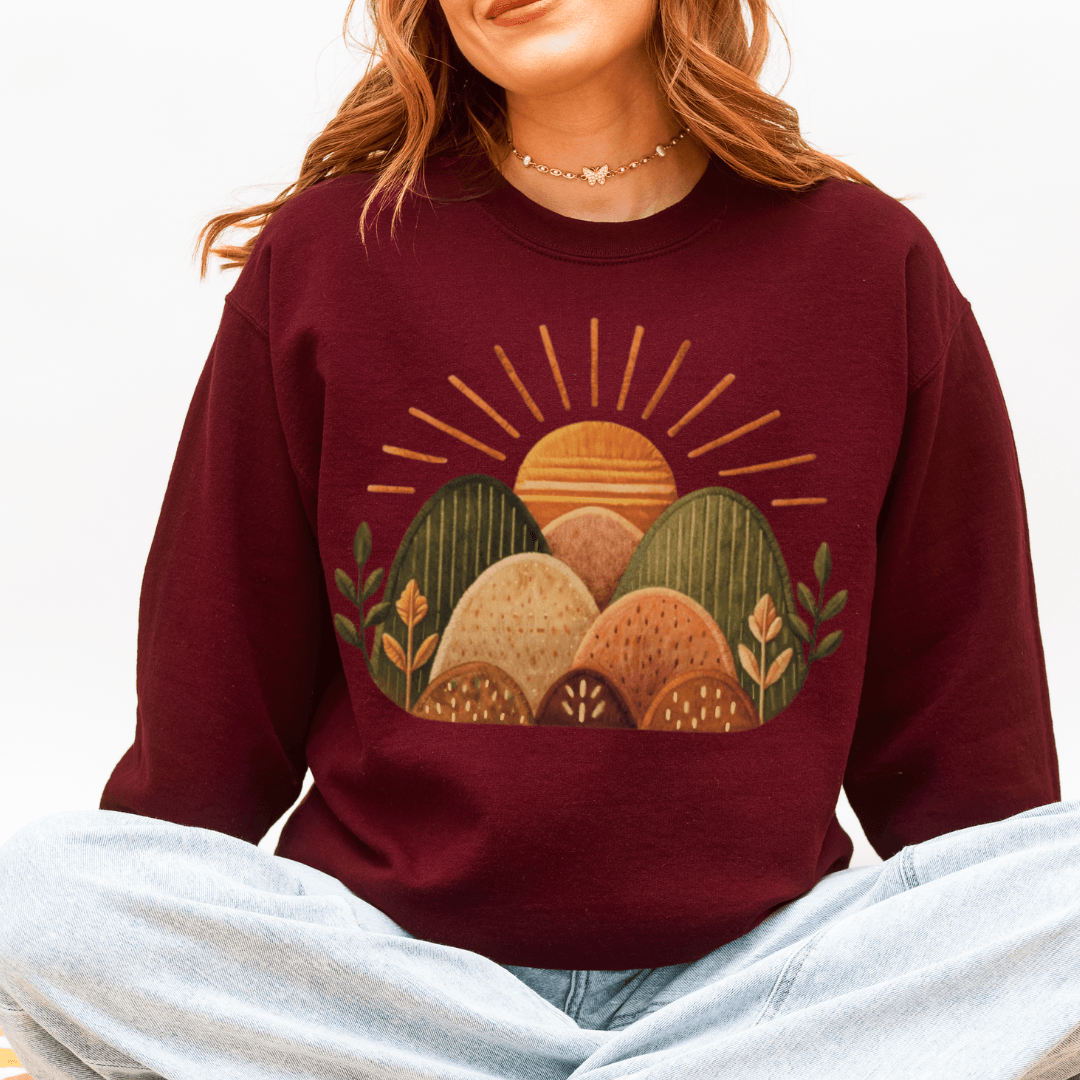 Sunrise Hills Crewneck Sweatshirt in Maroon — earthy sunrise folk art crewneck