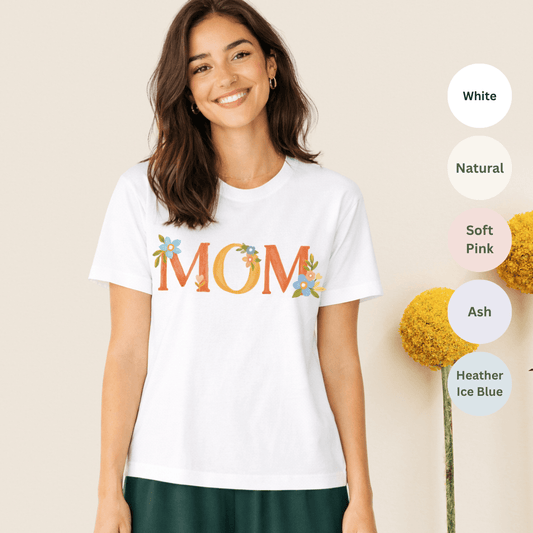 White Bella+Canvas 3001 t-shirt with floral MOM lettering in warm oranges and gentle blues
