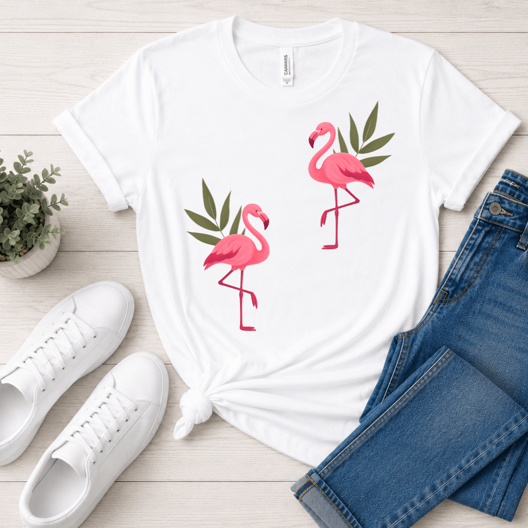White Bella+Canvas 3001 tee with pink flamingo folk graphic, flat lay