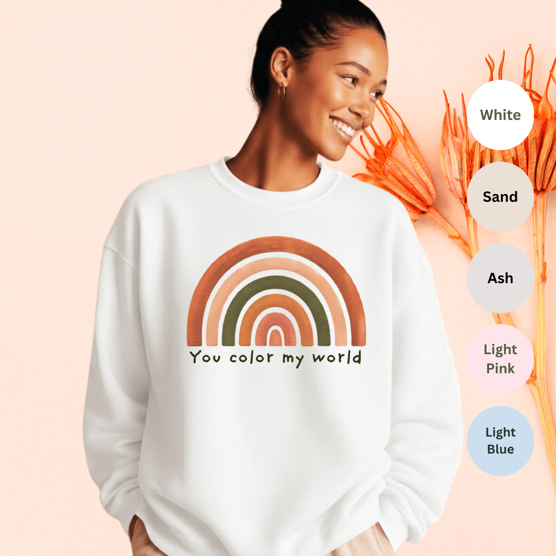 White Gildan 18000 crewneck sweatshirt with muted rainbow and "You color my world" hand-lettered graphic