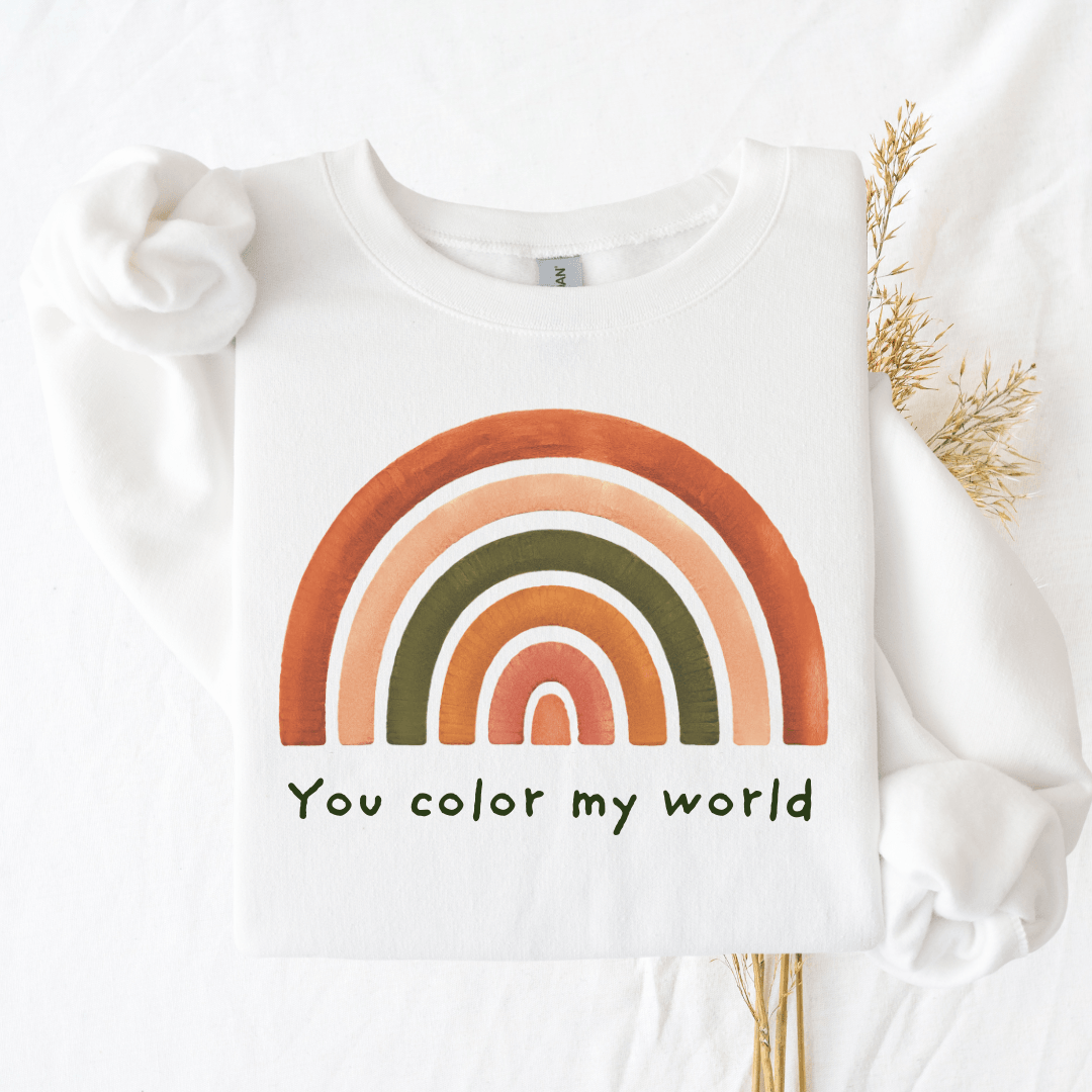 White Gildan 18000 sweatshirt with "You color my world" rainbow design, flat lay