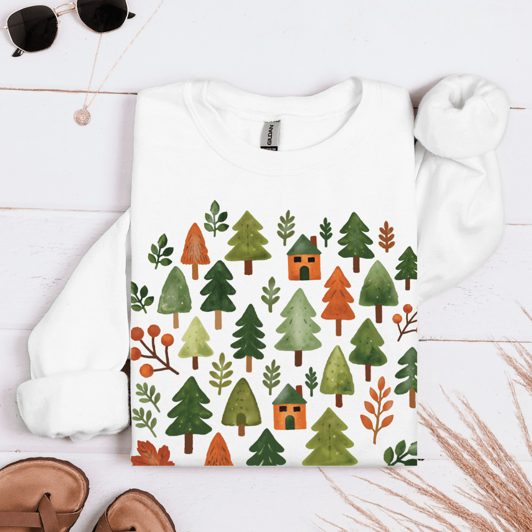 White Gildan 18000 sweatshirt with cozy forest trees and cabins design