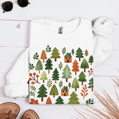 White Gildan 18000 sweatshirt with cozy forest trees and cabins design