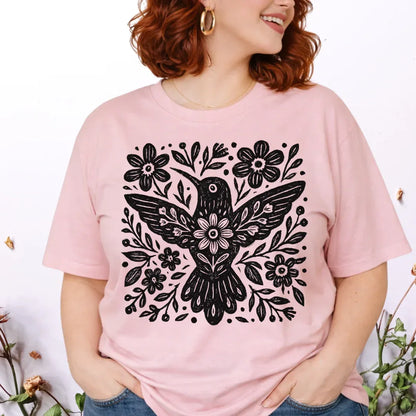 pink t-shirt with a black floral and bird design.