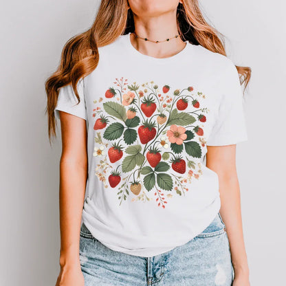 strawberry folk art t-shirt in natural setting — cottagecore boho style tee
